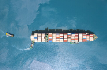 Wall Mural - Top view A large cargo ship is docking at the port. to load the goods