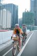 © Jonathan De Guzman - A young couple riding their bikes together in the city.