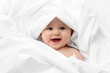 © Lisa Tichané - Smiling baby face wrapped in white sheet