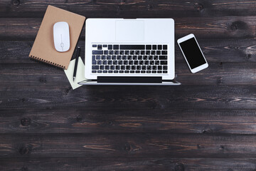 Wall Mural - Laptop computer with mouse, notepad and smartphone on wooden table