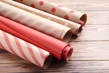 Canvas Print - Rolls of craft papers on brown wooden background