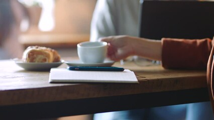 Poster - Hand, coffee and phone with a business woman writing notes in a cafe for remote work as a freelancer. Mobile, social media and coffee shop with a female startup entrepreneur working in a restaurant