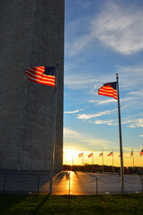 Wall Mural - Washington Monument and waving US flags and people in silhouettes during  sunset - Washington DC - United States