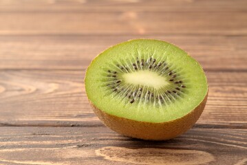 Wall Mural - Kiwi fruit half cut on wooden background