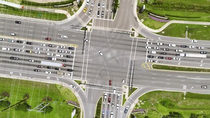 Wall Mural - Aerial view of large multilane road intersection with traffic lights and moving cars and trucks