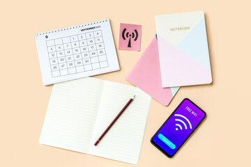 Wall Mural - Calendar, stationery supplies and mobile phone with WiFi symbol on color background