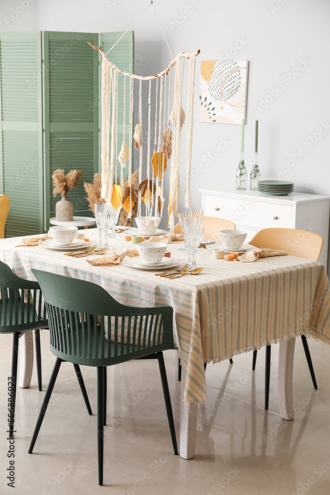 Table with stylish setting in light room