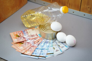 Almaty, Kazakhstan - 10.04.2022 : Various food products and banknotes of Kazakhstani tenge are laid out on the table.