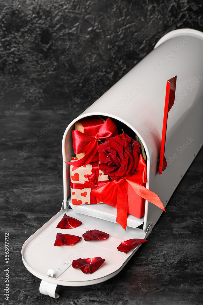 Mailbox with gifts and rose on dark background. Valentine's Day celebration