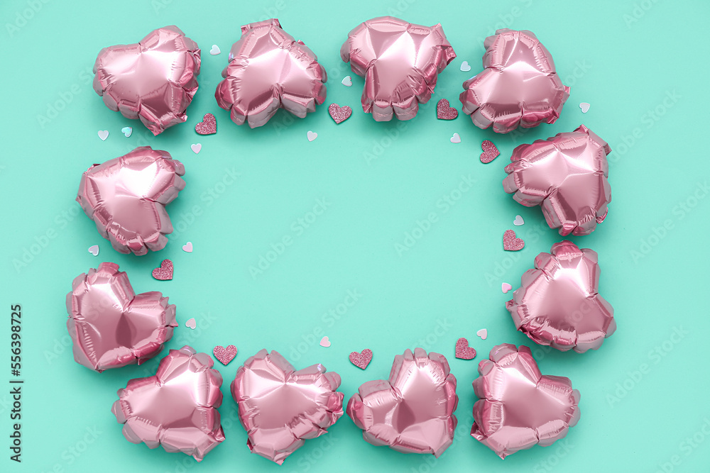 Frame made of heart-shaped balloons on green background. Valentine's Day celebration