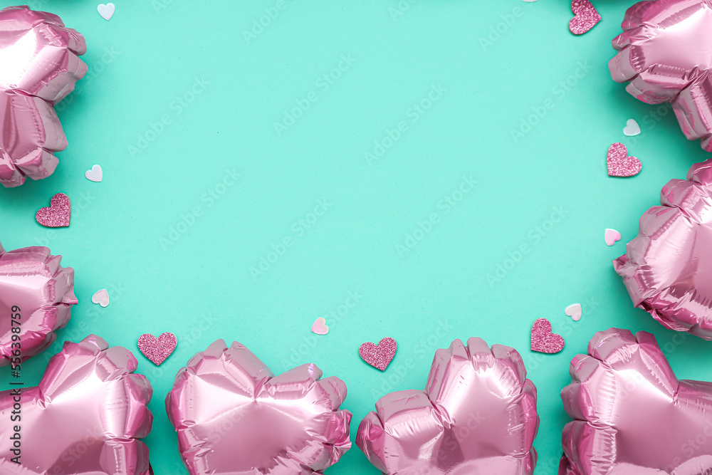 Frame made of heart-shaped balloons on green background. Valentine's Day celebration