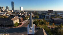 Oklahoma City Skyline In Autumn. Aerial Orbit Of Church Steeple In OKC USA.