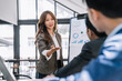 © NINENII - Asian businessman showing hand and smiling young team of colleagues making good business discussion in modern coworking office concept teamwork people.