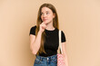 Young redhead woman with a hearts cloth bag cut out isolated looking sideways with doubtful and skeptical expression.