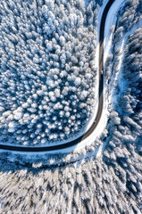Wall Mural - aerial view on the road and forest at the winter time.