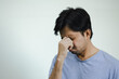 © anut21ng Stock - asian man feeling fatigue and headache. Stress and frustration concept