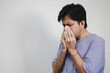 © anut21ng Stock - portrait Asian man coughing and sneezing