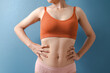 © NanSan - Close up pretty asian model with orange bra nice body isolated on background.