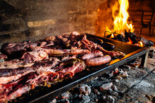 Barbeque, Bbq Meat Cooking On Grill. Traditional Asado Of Argentina, Paraguay Y Uruguay.