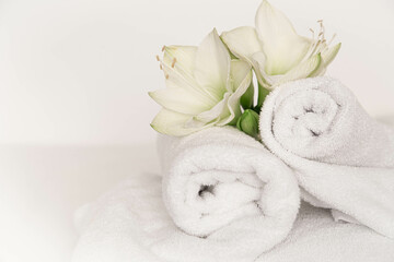 Wall Mural - Spa composition with lily flowers and towels on a white background.