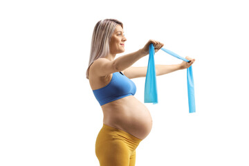 Wall Mural - Profile shot of a pregnant woman exercising with a stretching band