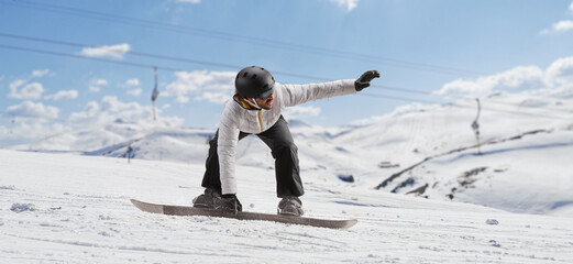 Sticker - Man gliding with a snowboard on a mountain