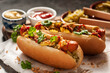 canvas print picture - Zwei Hotdogs mit Gurken, Röstzwiebeln, Ketchup und Senf