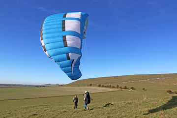 Poster - Paragliders launching from on a hill	