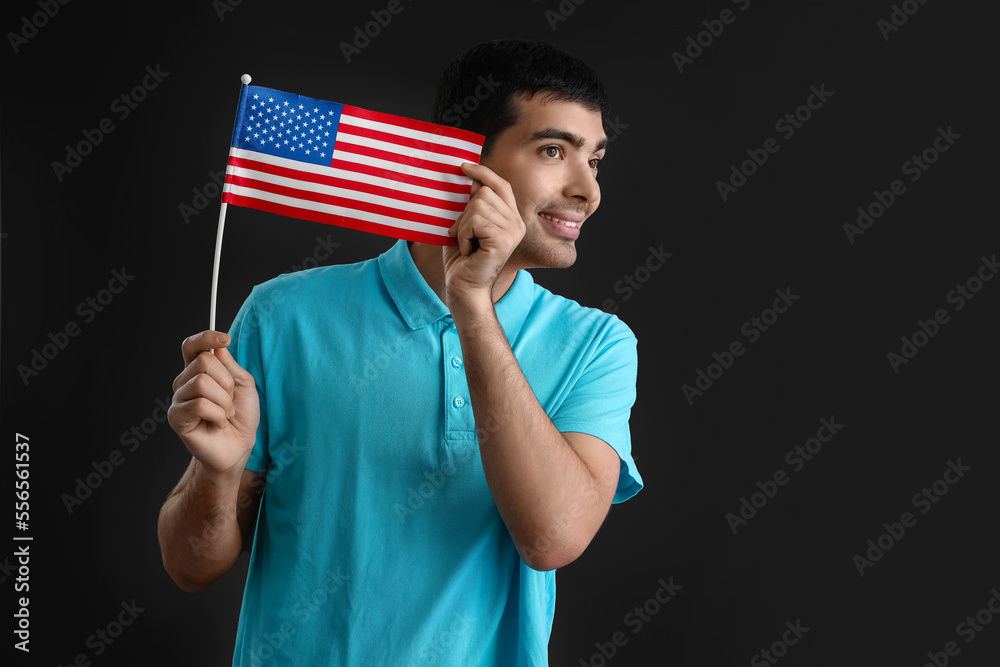 Young man with USA flag on black background