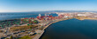 The Oakland Outer Harbor aerial view. Loaded trucks moving by Container cranes. View of busy Port of Oakland. Shipping terminal facility.