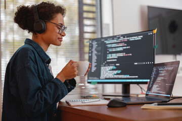 Female freelancer making new project as web designer and programmer on her computer at home office