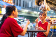 © CandyRetriever  - Happy Asian family on summer holiday travel vacation. Adult mother and daughter enjoy and fun outdoor city lifestyle shopping and eating street food together at Bangkok Chinatown street night market.