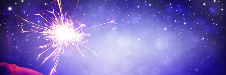 Wall Mural - Happy New Year background with glowing sparklers.