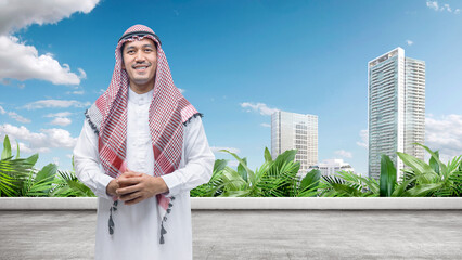 Wall Mural - Arab man wearing keffiyeh and agal standing in the city