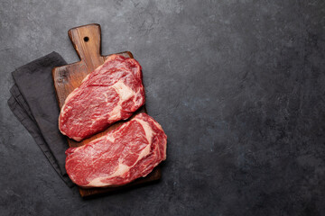 Wall Mural - Two raw ribeye beef steaks