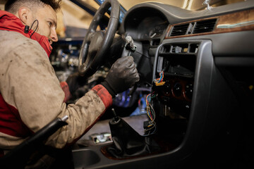 disassemble the center console of the car torpedo for interior detailing and repair.