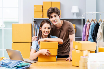 Young Asian couple business working in house office look like doing startup business and smiling happy and positive,Surprise of couple success on making big sale of his online store.