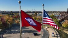 Arkansas State And USA Flag On Sunny Day During Golden Hour Light. Aerial View At Little Rock.