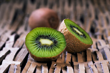 Wall Mural - Ripe kiwi and half kiwi on texture background, protein load.