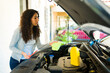 © AntonioDiaz - Young woman changing the oil of her car