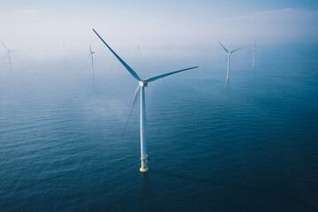 Wind turbine. Aerial view of wind turbines or windmills farm field in blue sea in Finland.