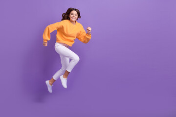 Wall Mural - Full length profile photo of excited active person jump hurry run empty space isolated on violet color background
