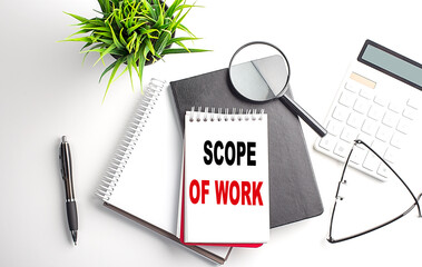 Poster - SCOPE OF WORK text on white paper. the inscription on the notebook