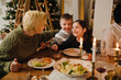 © Drobot Dean - Mother having fun with her kids during Christmas dinner