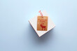 © Designpics - Overhead View of Christmas Gift Box with Peace on Earth Tag, Studio Shot