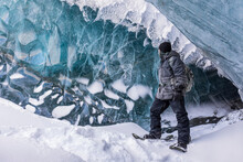 Fort Greely Soldier Observing The Ice Inside A Cave On Canwell Glacier In The Delta Mountains Of The Alaska Range; Alaska, United States Of America
