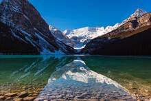 Lake Louise Reflecting The Rocky Mountains With Snow In Autumn, Banff National Park; Alberta, Canada