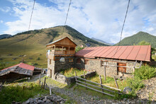 A Hotel, With Power Lines And Traditional Stone House And Wooden Balcony In The Historic Village Of Shenako In The Tusheti National Park; Shenako, Kakheti, Georgia
