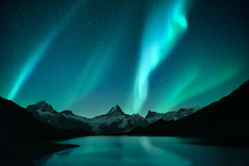 aurora borealis. northern lights in winter mountains. sky with polar lights and stars. stars reflect