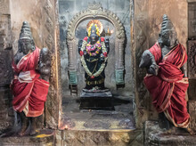 Alcove With Hindu Deity Statue In Wall With Guardian Statues Wrapped In Silk On Either Side At The Dravidian Chola Era Airavatesvara Temple; Darasuram, Tamil Nadu, India